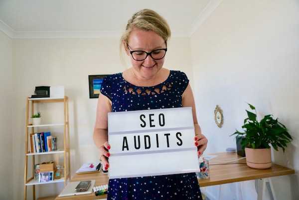 SEO Specialist Casey Bryan Holding an SEO Audits sign