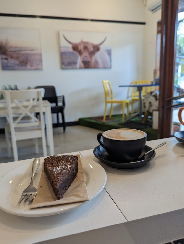 Coffee and a slice of chocolate brownie in Salty Cow